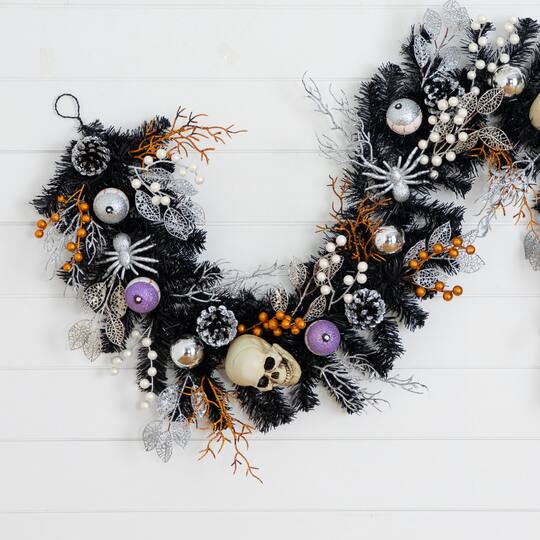6ft. Artificial Halloween Black Garland with Skulls, Eyeballs & Spiders